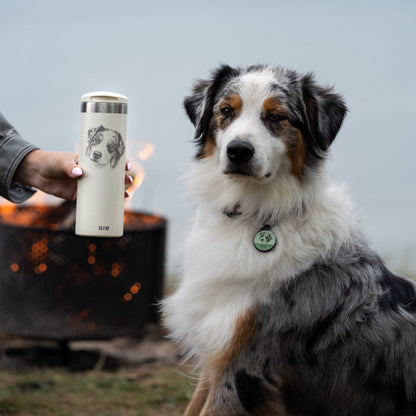 Australian Shepherd next to a cream tumbler with his own portrait